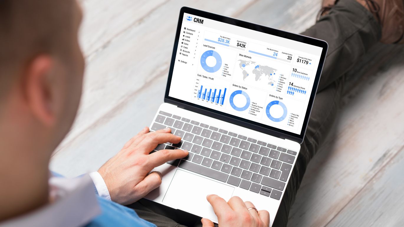 Professional celebrating success while working on a laptop